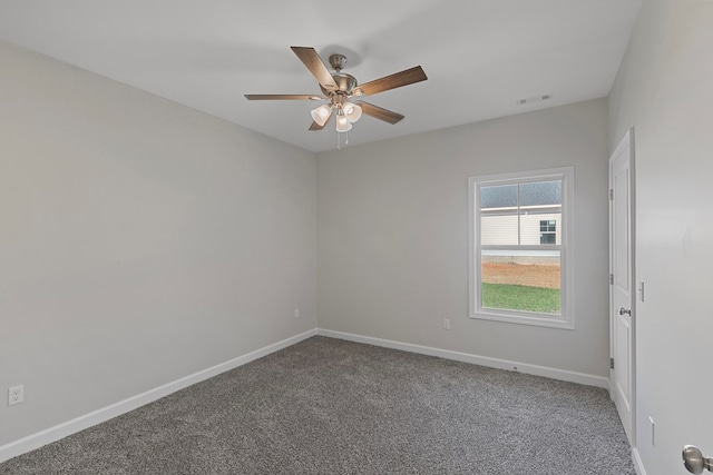 carpeted spare room featuring ceiling fan