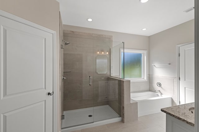 bathroom featuring tile patterned flooring, vanity, and separate shower and tub