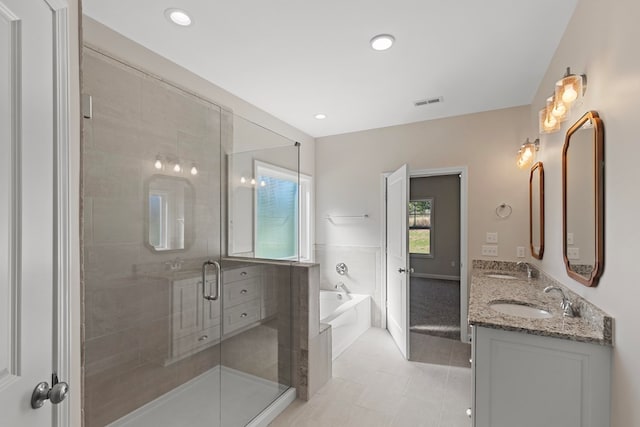 bathroom featuring tile patterned flooring, vanity, and plus walk in shower