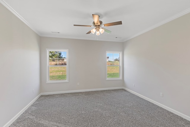 carpeted empty room featuring ceiling fan, crown molding, and a wealth of natural light