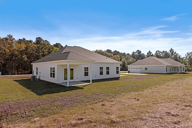 rear view of house featuring a yard, a patio, and cooling unit