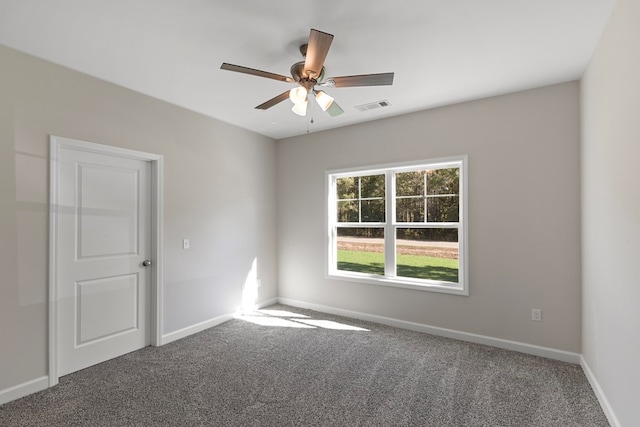 carpeted spare room with ceiling fan