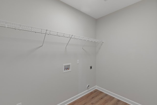 clothes washing area featuring washer hookup, wood-type flooring, and hookup for an electric dryer