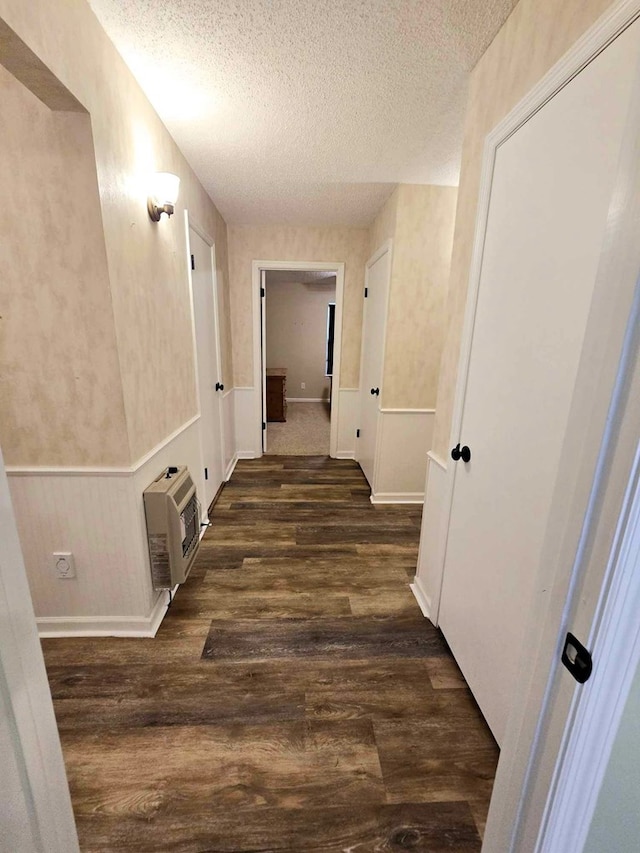 653 Honeysuckle Hills Rd, Ozark, AL 36360 - hallway featuring heating unit, a textured ceiling, and dark wood-type flooring