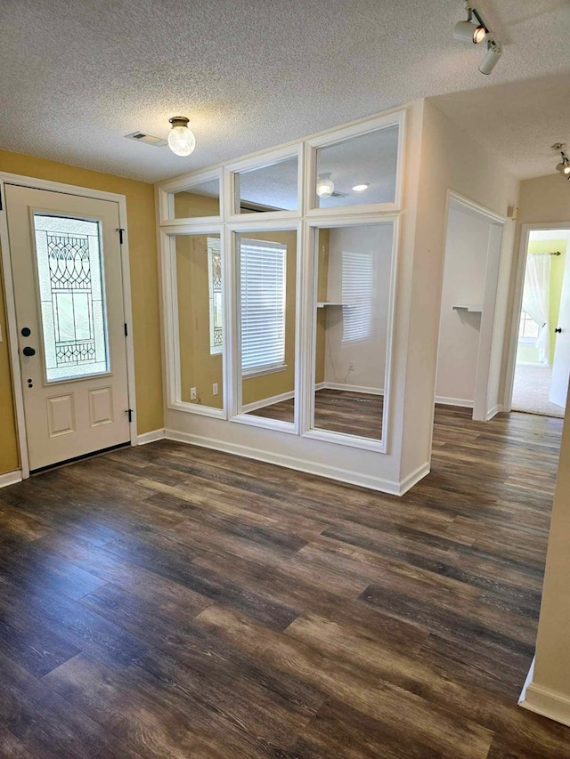 653 Honeysuckle Hills Rd, Ozark, AL 36360 - entryway with a textured ceiling, dark wood-style flooring, healthy amount of natural light, and baseboards