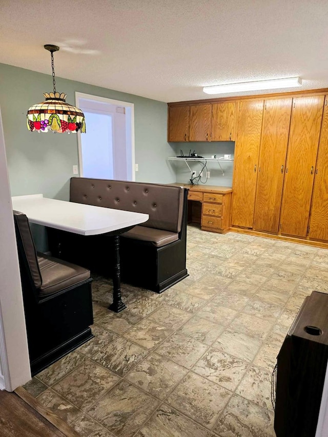 653 Honeysuckle Hills Rd, Ozark, AL 36360 - kitchen featuring brown cabinets, pendant lighting, and light countertops