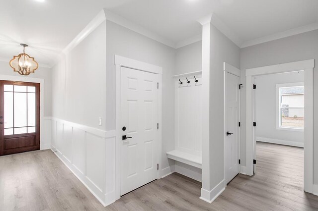 kitchen featuring pendant lighting, french doors, white cabinetry, and a kitchen island with sink