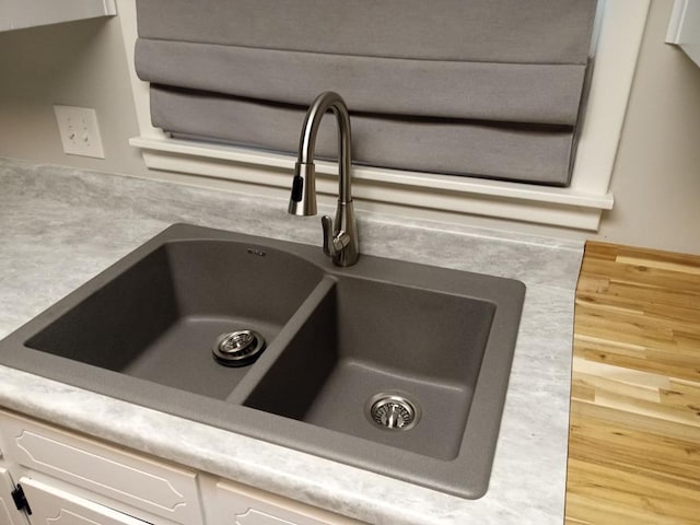 details with white cabinets and sink