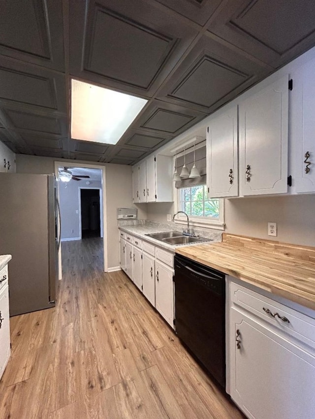 kitchen with sink, black dishwasher, and white cabinetry