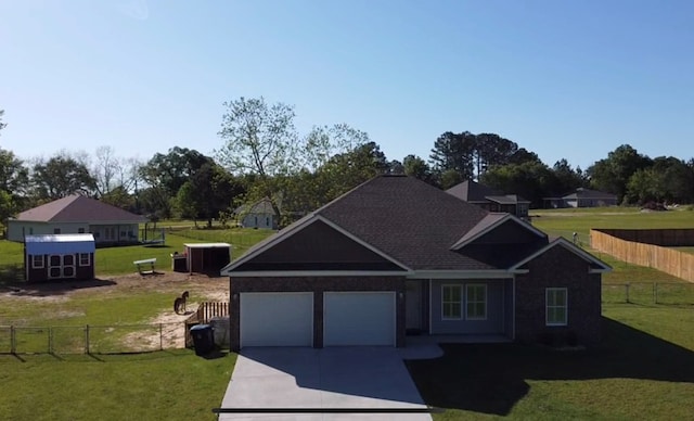 view of front of house featuring concrete driveway, an attached garage, fence, and a front lawn