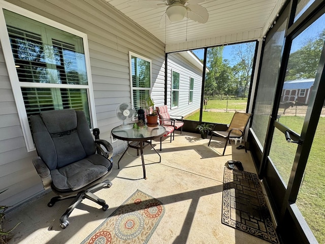 sunroom / solarium with ceiling fan and a healthy amount of sunlight