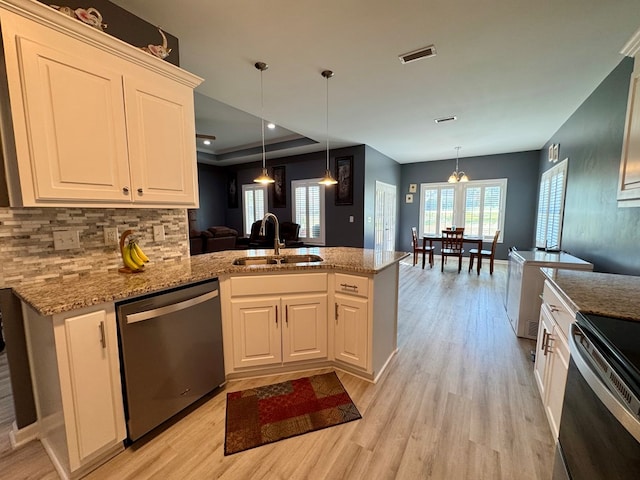 kitchen with stainless steel appliances, visible vents, a sink, and light wood-style floors