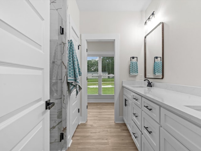 146 County Road 657, Chancellor, AL 36316 - bathroom featuring double vanity, a marble finish shower, and wood finished floors