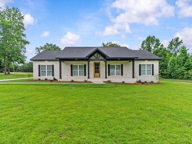 146 County Road 657, Chancellor, AL 36316 - view of front of property with a front lawn, brick siding, a shingled roof, and a porch