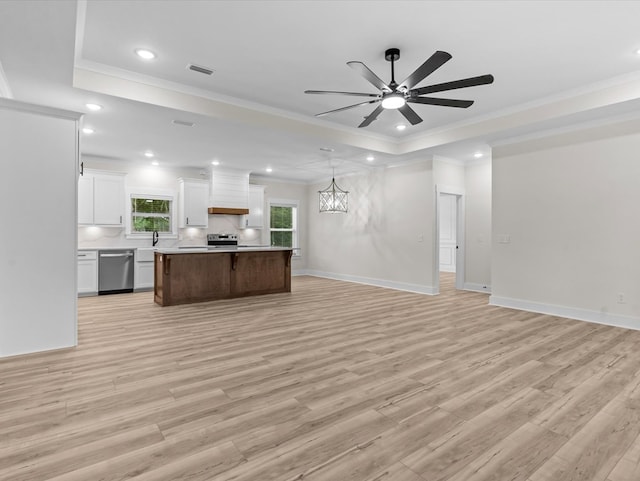 146 County Road 657, Chancellor, AL 36316 - unfurnished living room with light wood finished floors, a tray ceiling, ornamental molding, a ceiling fan, and recessed lighting