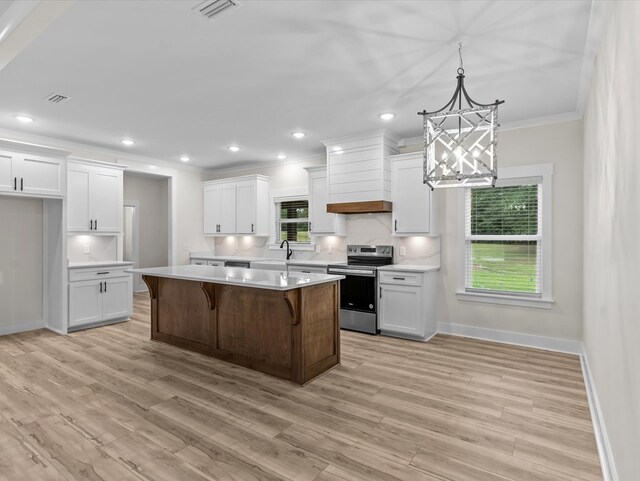 146 County Road 657, Chancellor, AL 36316 - kitchen featuring stainless steel range with electric cooktop, ornamental molding, a chandelier, premium range hood, and light countertops