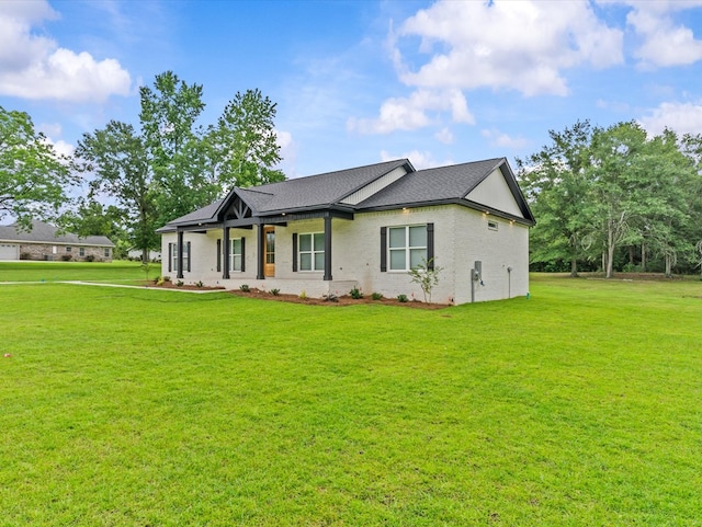 146 County Road 657, Chancellor, AL 36316 - view of front facade with a front yard, brick siding, and roof with shingles