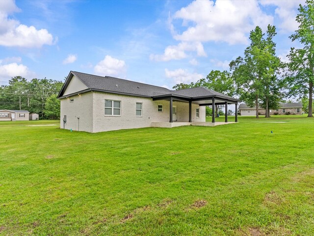 146 County Road 657, Chancellor, AL 36316 - rear view of house featuring a patio, a lawn, and roof with shingles
