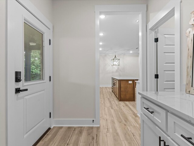 146 County Road 657, Chancellor, AL 36316 - hallway featuring light wood finished floors and a chandelier