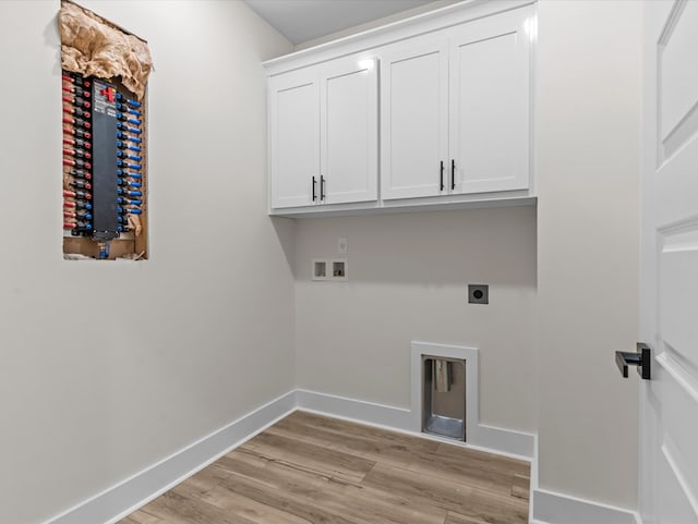 146 County Road 657, Chancellor, AL 36316 - laundry area featuring electric dryer hookup, cabinet space, hookup for a washing machine, and light wood finished floors