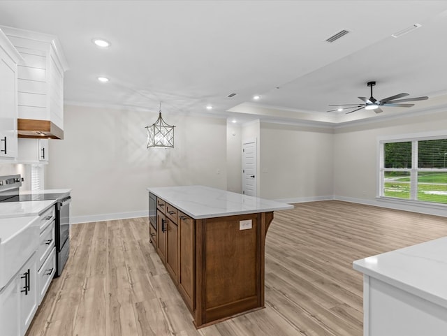 146 County Road 657, Chancellor, AL 36316 - kitchen featuring stainless steel electric stove, light wood-style flooring, a center island, a ceiling fan, and white cabinetry