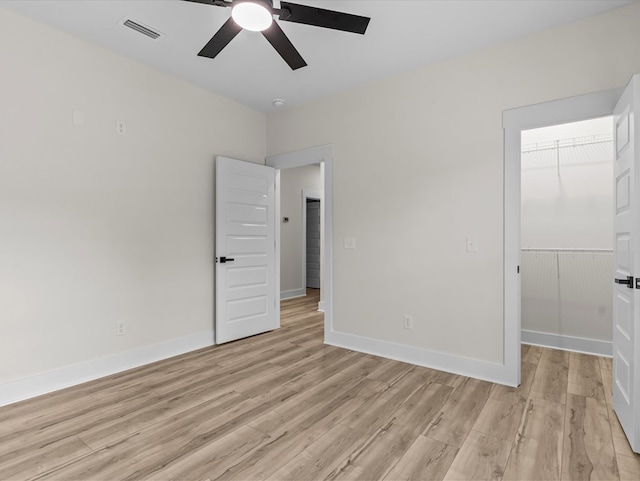 146 County Road 657, Chancellor, AL 36316 - unfurnished bedroom with light wood-style floors, a walk in closet, a closet, and a ceiling fan