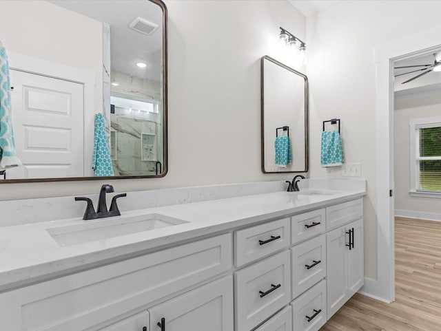 146 County Road 657, Chancellor, AL 36316 - bathroom featuring a marble finish shower, double vanity, and wood finished floors