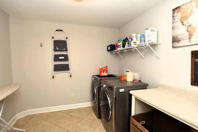 laundry room with baseboards, separate washer and dryer, laundry area, and light tile patterned flooring