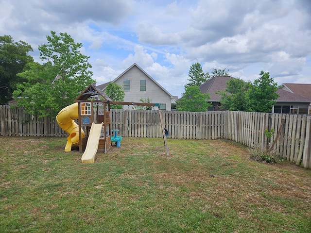 view of yard with a fenced backyard and a playground