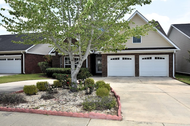 view of front of property featuring brick siding and driveway