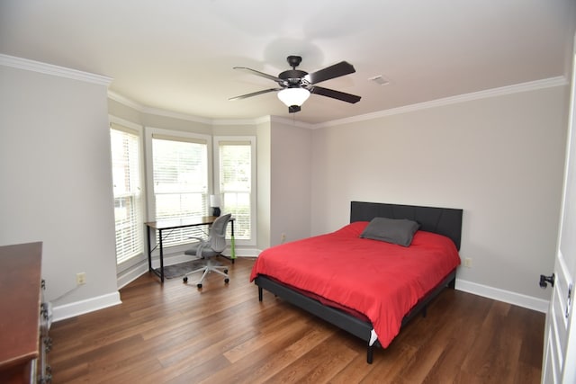 bedroom featuring baseboards, crown molding, and wood finished floors