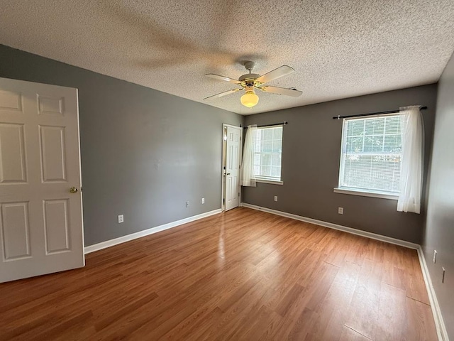 291 Nomad Cir, Kinsey, AL 36303 - empty room with wood finished floors, a ceiling fan, and a textured ceiling
