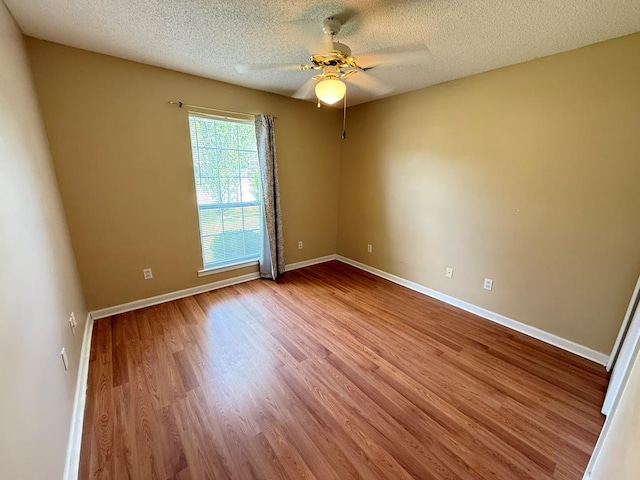 291 Nomad Cir, Kinsey, AL 36303 - empty room featuring a ceiling fan, wood finished floors, and a textured ceiling