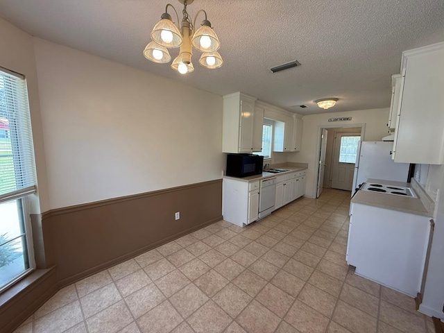 291 Nomad Cir, Kinsey, AL 36303 - kitchen featuring white appliances, a chandelier, white cabinets, light countertops, and a textured ceiling