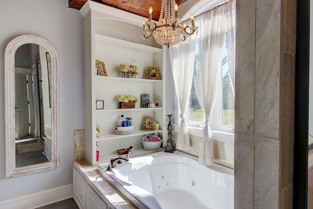 bathroom featuring a tub to relax in and a notable chandelier