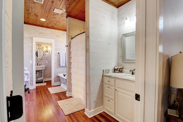 bathroom with vanity, wood walls, plus walk in shower, wood-type flooring, and wood ceiling