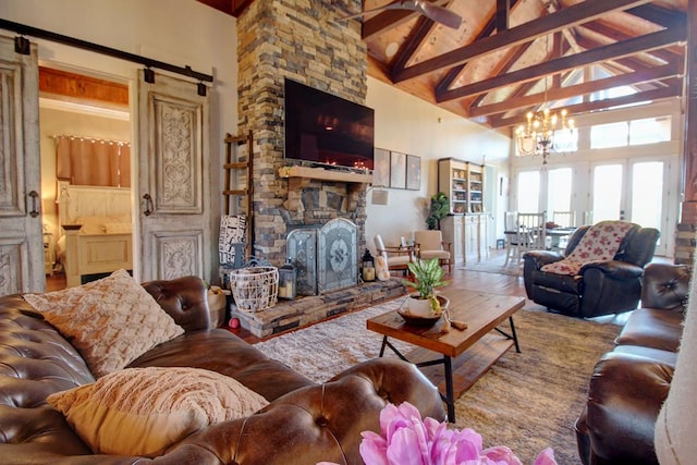 living room featuring a notable chandelier, beam ceiling, a fireplace, and high vaulted ceiling