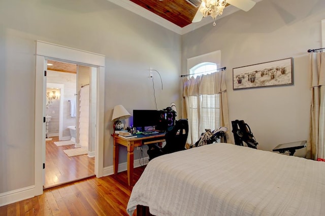 bedroom featuring connected bathroom, ceiling fan, wood-type flooring, and ornamental molding