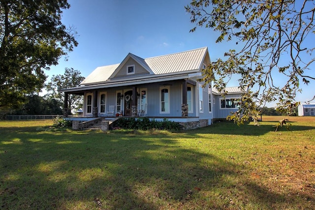 farmhouse inspired home with a porch and a front lawn