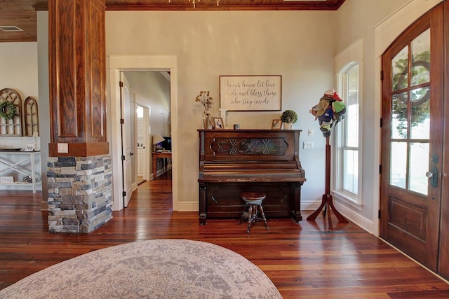 interior space featuring plenty of natural light, dark wood-type flooring, and ornamental molding