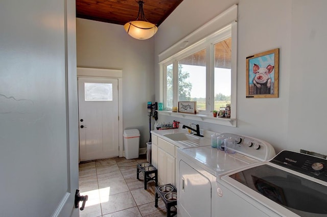 washroom with washing machine and clothes dryer, sink, cabinets, light tile patterned floors, and wood ceiling