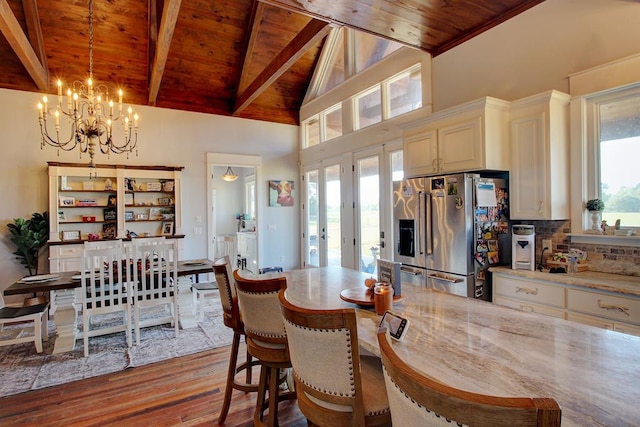 dining area featuring a chandelier, french doors, wooden ceiling, and light hardwood / wood-style floors