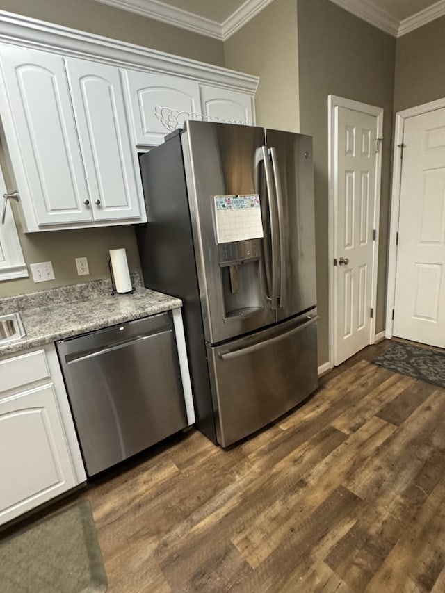 kitchen featuring white cabinetry, stainless steel appliances, and ornamental molding