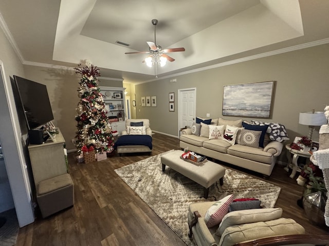 living room featuring ornamental molding and a tray ceiling