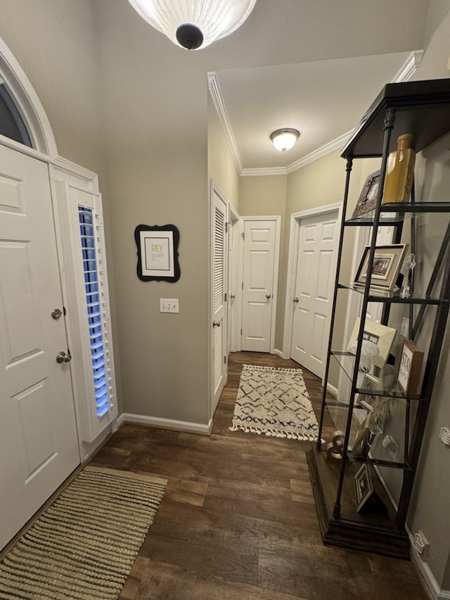 foyer entrance with dark hardwood / wood-style floors and ornamental molding