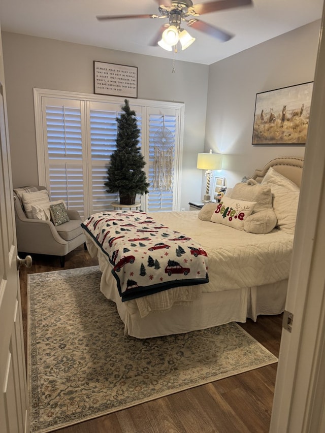 bedroom featuring dark hardwood / wood-style flooring and ceiling fan