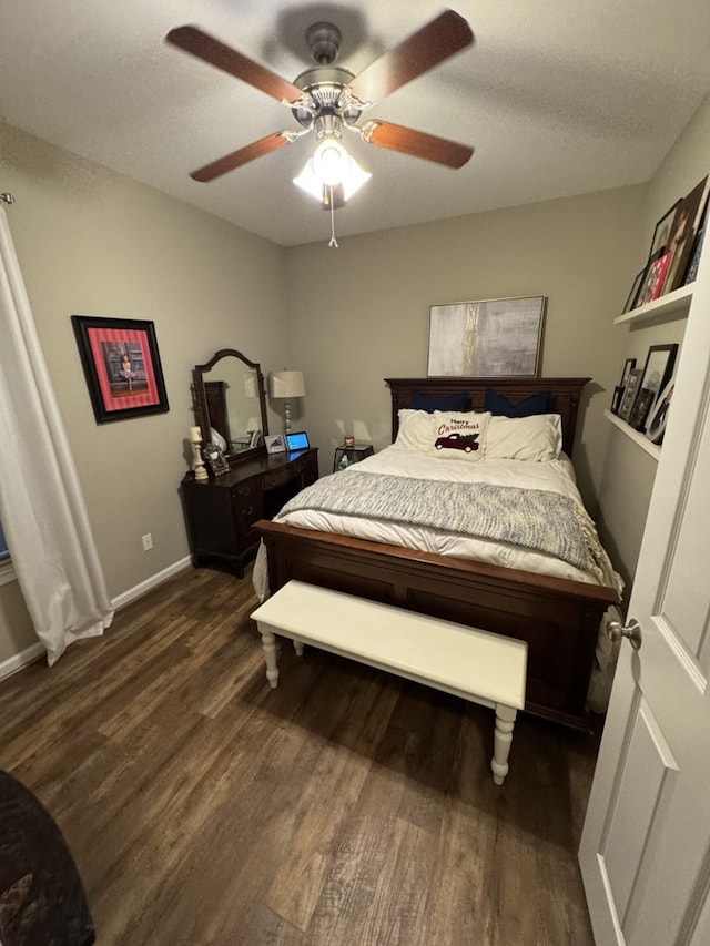 bedroom featuring a textured ceiling, ceiling fan, and dark wood-type flooring