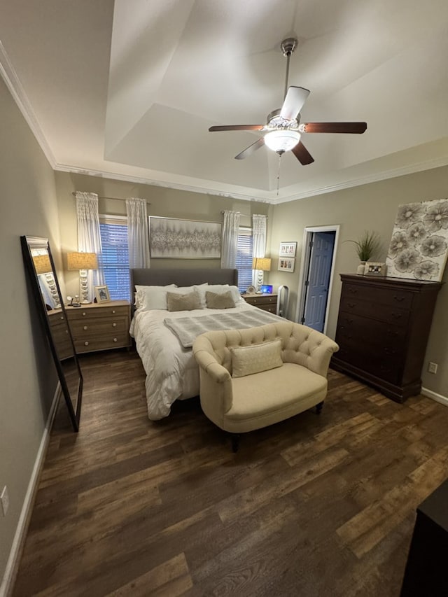 bedroom with a tray ceiling, ceiling fan, crown molding, and dark hardwood / wood-style floors