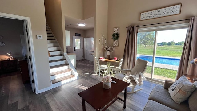 208 Reardon, Rehobeth, AL 36301 - living area featuring stairs, wood finished floors, a towering ceiling, and baseboards