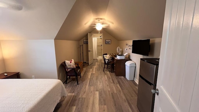 208 Reardon, Rehobeth, AL 36301 - bedroom with freestanding refrigerator, wood finished floors, lofted ceiling, and ceiling fan